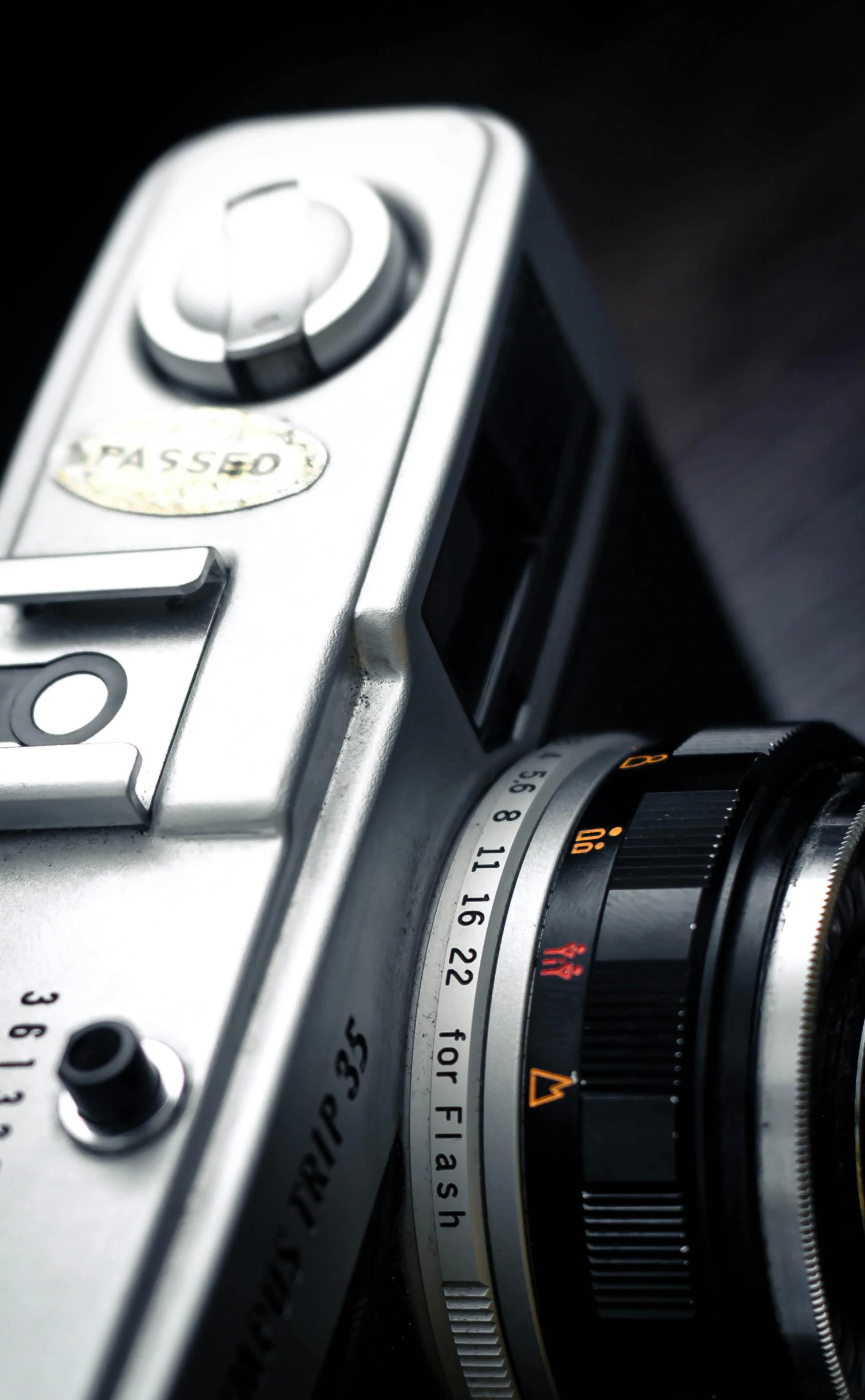 a silver camera sitting on top of a table, a macro photograph, by David Simpson, tourist photo