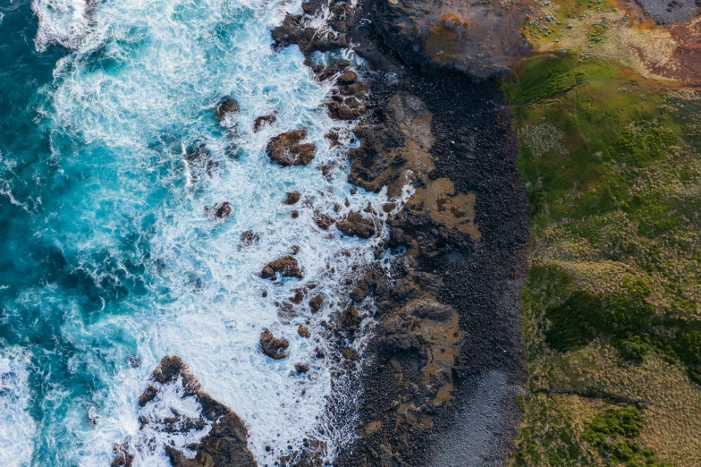 a large body of water next to a rocky shore, pexels contest winner, birdseye view, te pae, 8k detail post processing, alana fletcher