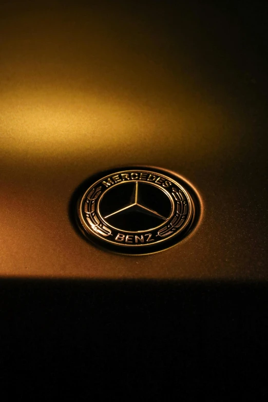 a mercedes emblem on the hood of a car, by Kev Walker, pexels contest winner, holography, brown and gold, glowing interior components, paul barson, embossed