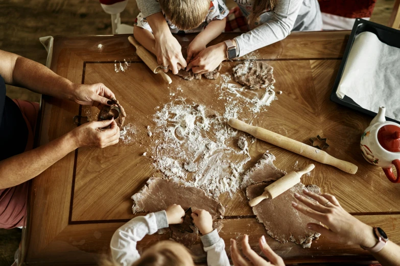 a group of people that are sitting around a table, by Matthias Stom, trending on pexels, process art, baking cookies, kids playing, rustic, 15081959 21121991 01012000 4k