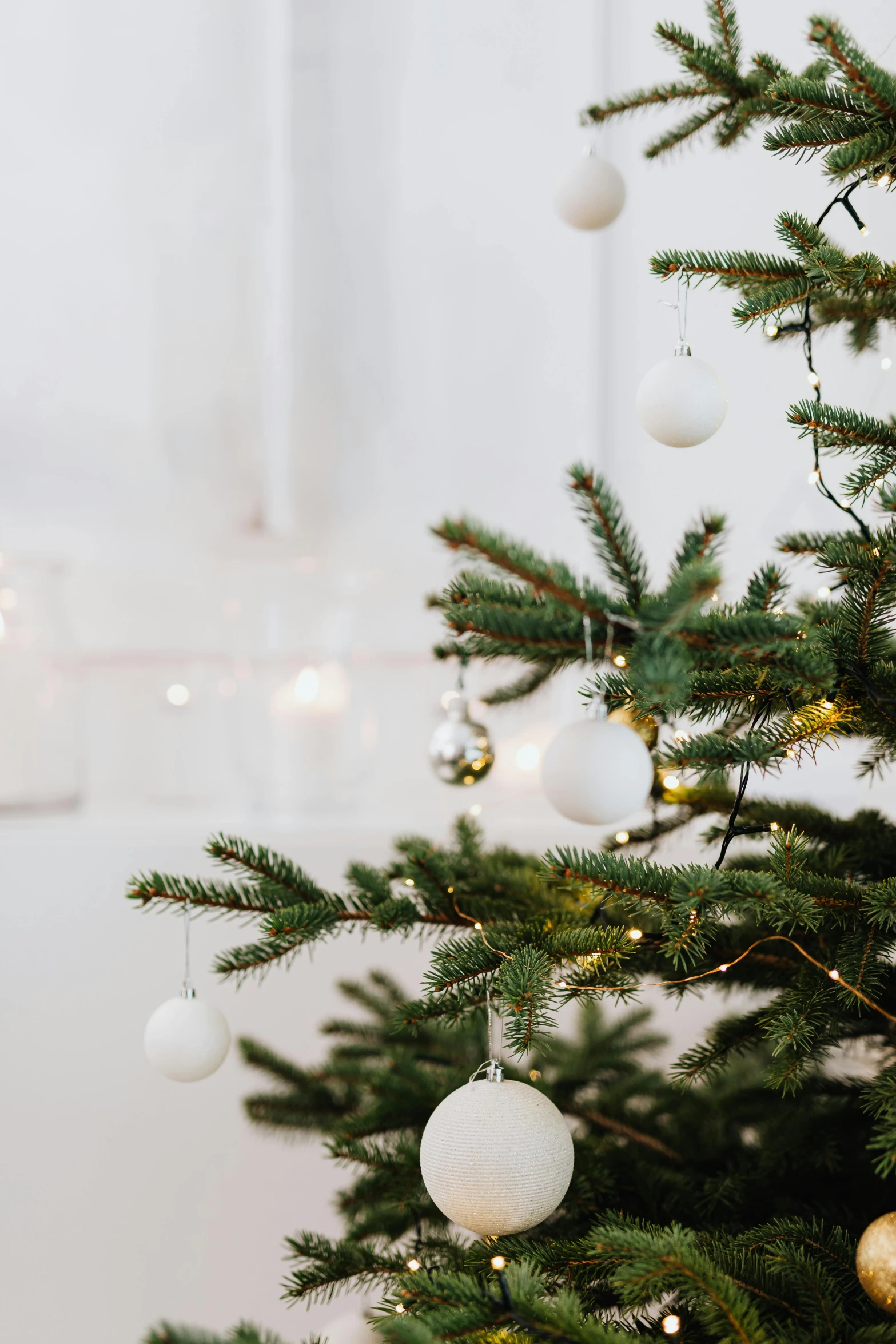 a christmas tree decorated with white and gold ornaments, pexels, minimalism, bright nordic forest, natural candle lighting, pale greens and whites, bright sky