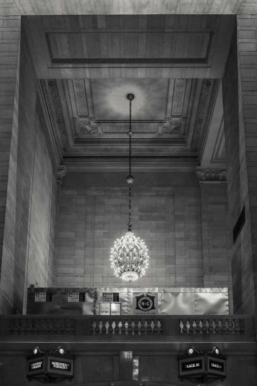 a black and white photo of the inside of a building, inspired by Vivian Maier, unsplash contest winner, big chandelier, white marble interior photograph, at night time, set inside of the bank