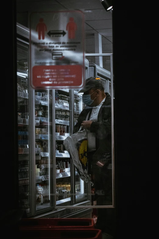 a man that is standing in the doorway of a store, vending machine, ap news, high quality photo, black man