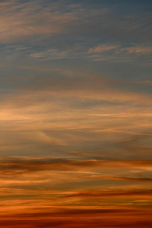 a plane flying in the sky at sunset, by David Simpson, romanticism, abstract photography, brown, multicoloured