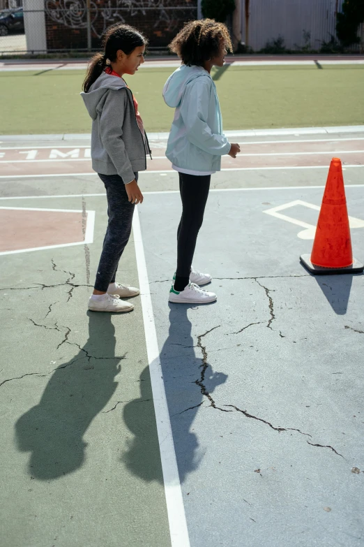 a couple of girls standing on top of a tennis court, an album cover, unsplash, incoherents, subsurface cracks, 15081959 21121991 01012000 4k, people outside walk, rinko kawauchi