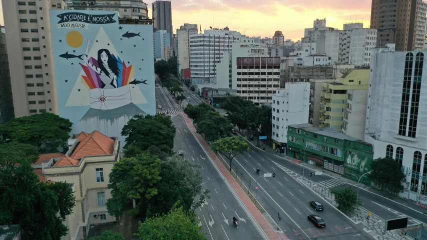 a city street filled with lots of tall buildings, a picture, by Felipe Seade, street art, at dawn, aerial footage, edu souza, photo from 2022