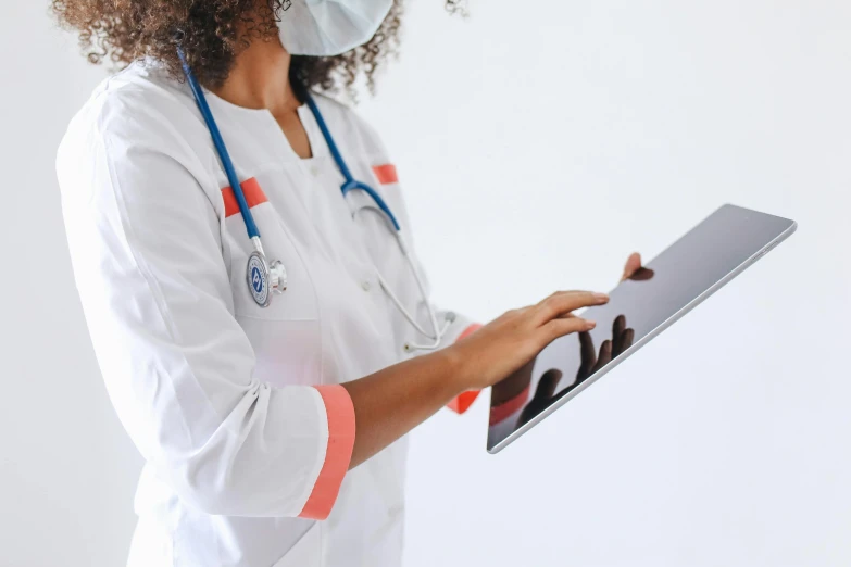a woman in a white lab coat holding a tablet computer, pexels, nurse costume, multiple stories, brown, gray