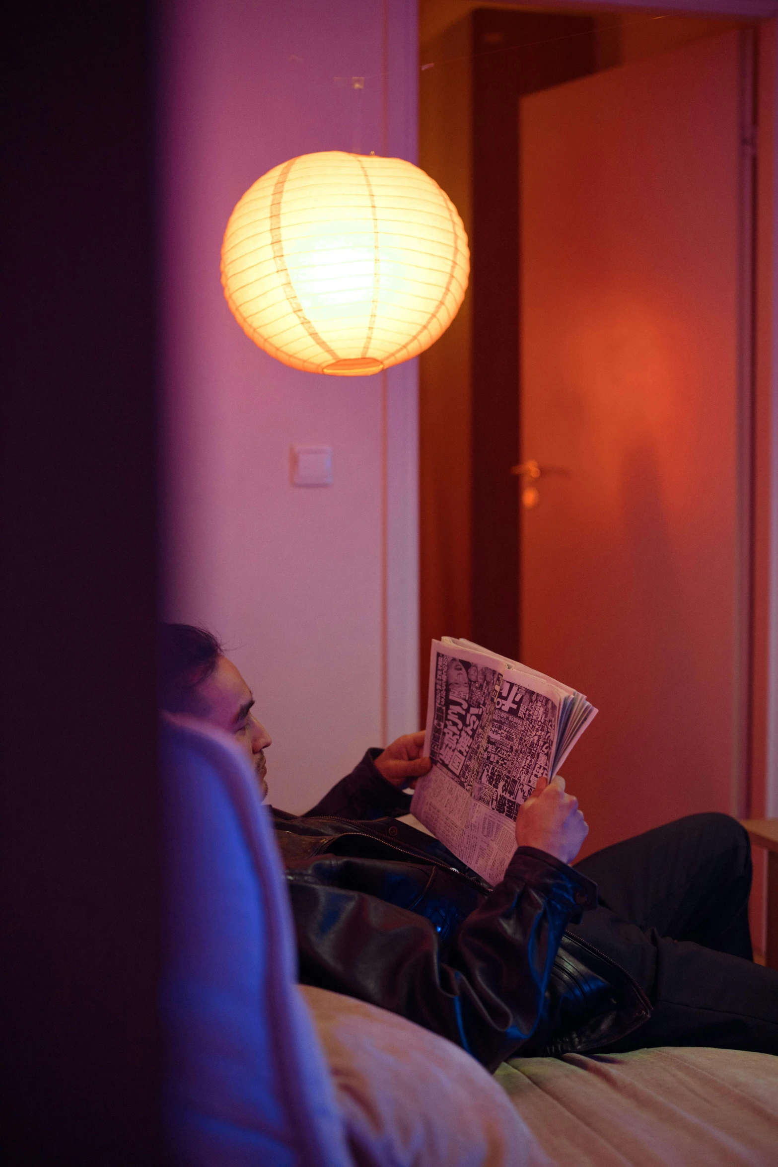 a person laying on a bed reading a book, by Jan Tengnagel, happening, cinematic neon uplighting, inside a cozy apartment, reading a newspaper, cinematic shot ar 9:16 -n 6 -g