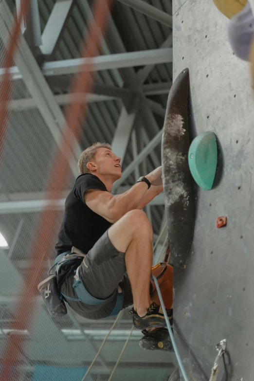 a man climbing up the side of a rock wall, 15081959 21121991 01012000 4k, indoor, rik oostenbroek, instagram story