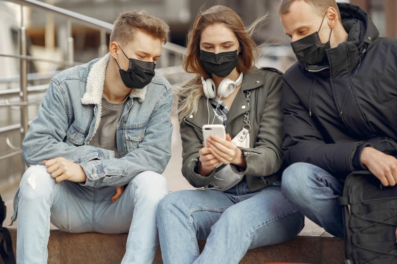 a group of people sitting next to each other on a bench, trending on pexels, happening, black facemask, phone, wearing jeans and a black hoodie, avatar image