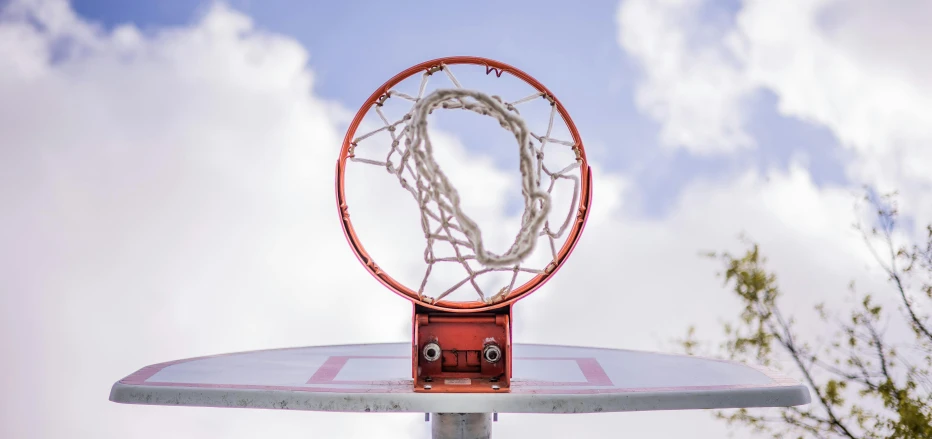 a basketball hoop with a basketball going through it, an album cover, pexels contest winner, uniform off - white sky, playground, netting, profile image