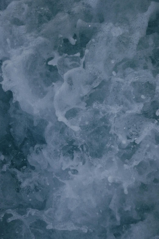 a man riding a wave on top of a surfboard, inspired by Vija Celmins, trending on unsplash, baroque, made of ice, cloud nebula, texture detail, prussian blue