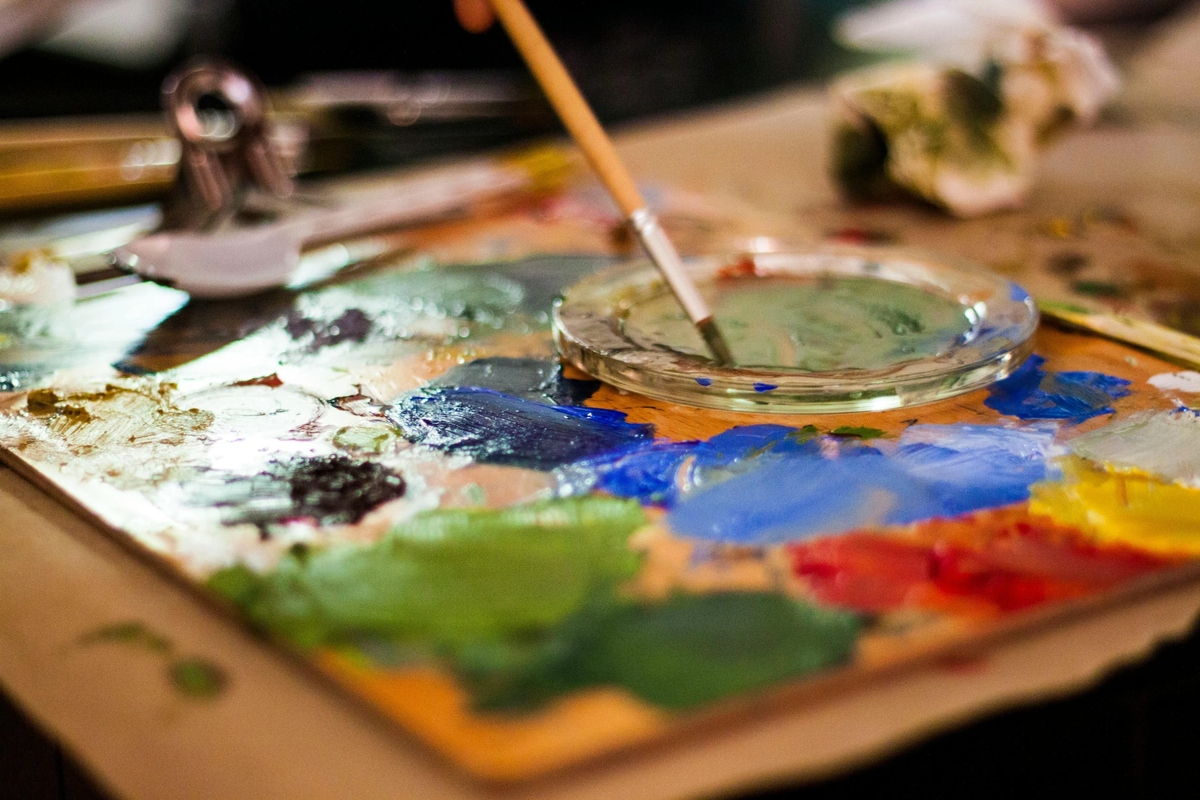 a close up of a paint palette on a table, a photorealistic painting, trending on pexels, process art, green and blue palette, intricate oils, paint knife, model painting