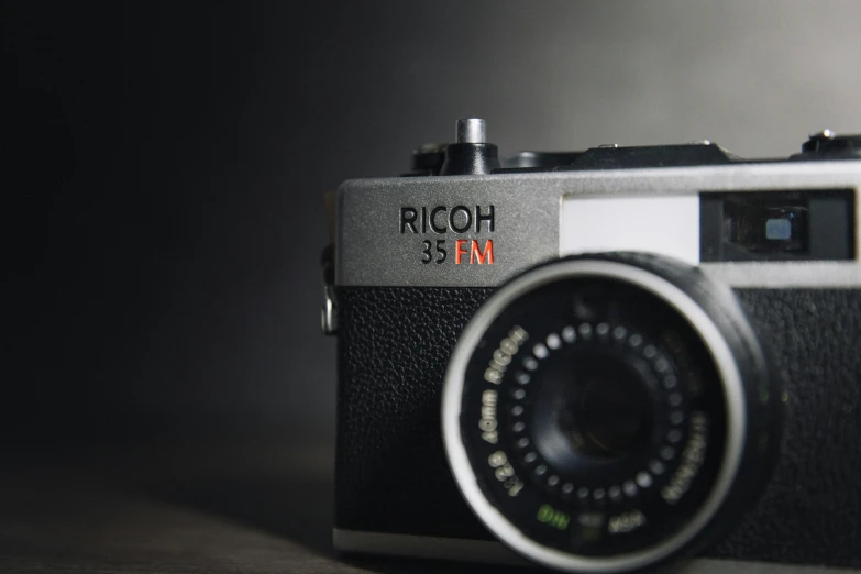 a close up of a camera on a table, by Kurt Roesch, unsplash contest winner, photorealism, on a gray background, shot on nicon camera, medium format. soft light, pochi iida