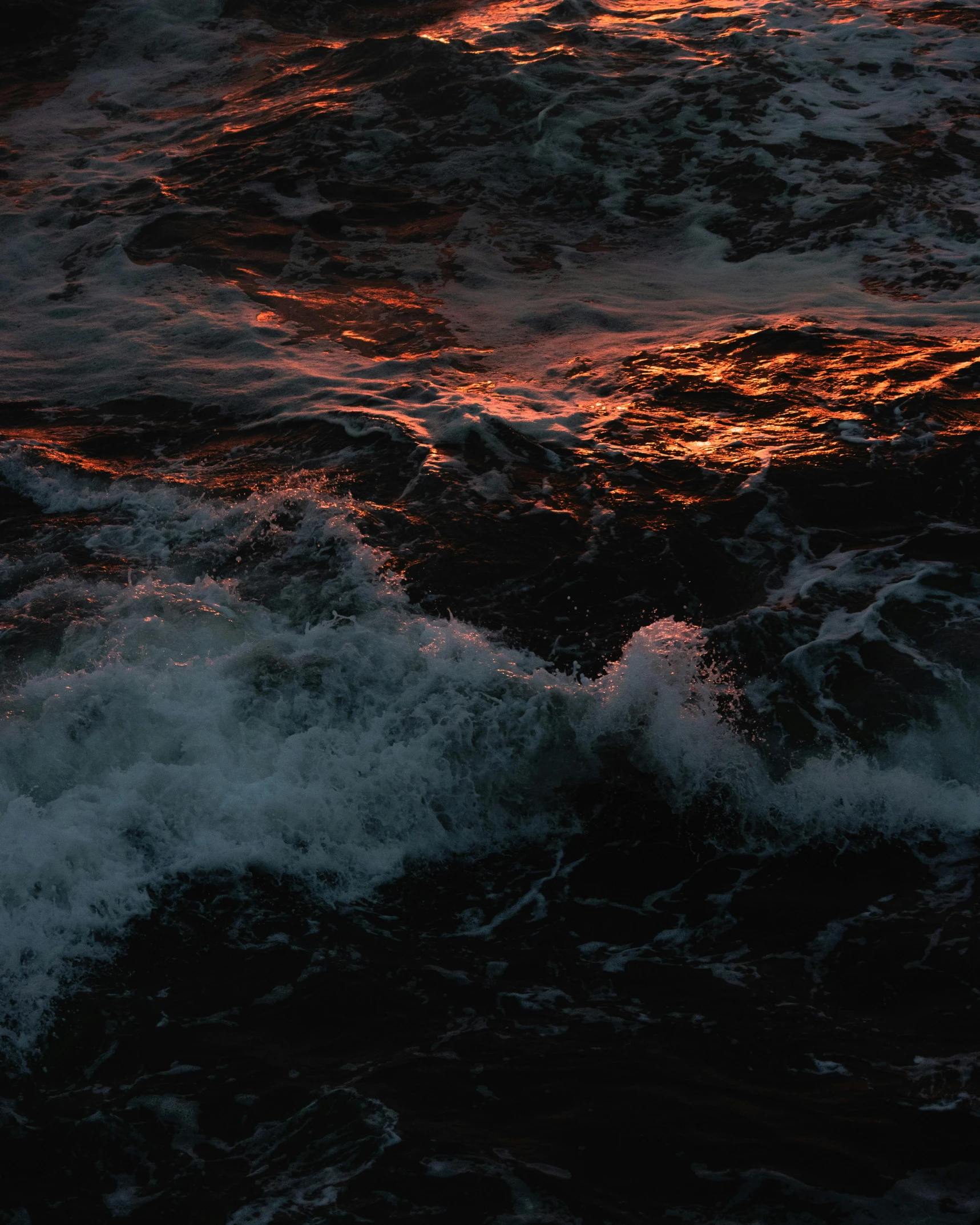 a man riding a surfboard on top of a wave in the ocean, an album cover, by Elsa Bleda, pexels contest winner, red glowing veins, lake filed with molten gold, nighttime, deep sadness