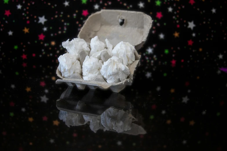 a carton filled with snow sitting on top of a table, inspired by Ödön Márffy, asteroids, 4k polymer clay food photography, meteorites, thc