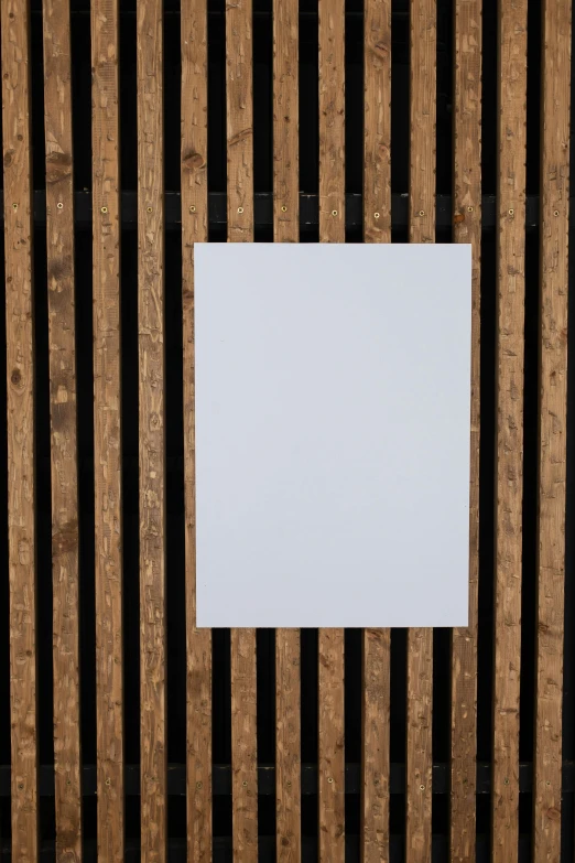 a piece of paper sitting on top of a wooden wall, a poster, by Doug Ohlson, no - text no - logo, whitespace, square, brown