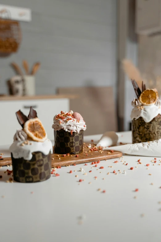 a couple of cupcakes sitting on top of a counter, wood cups, profile image, stroopwaffel, seeds