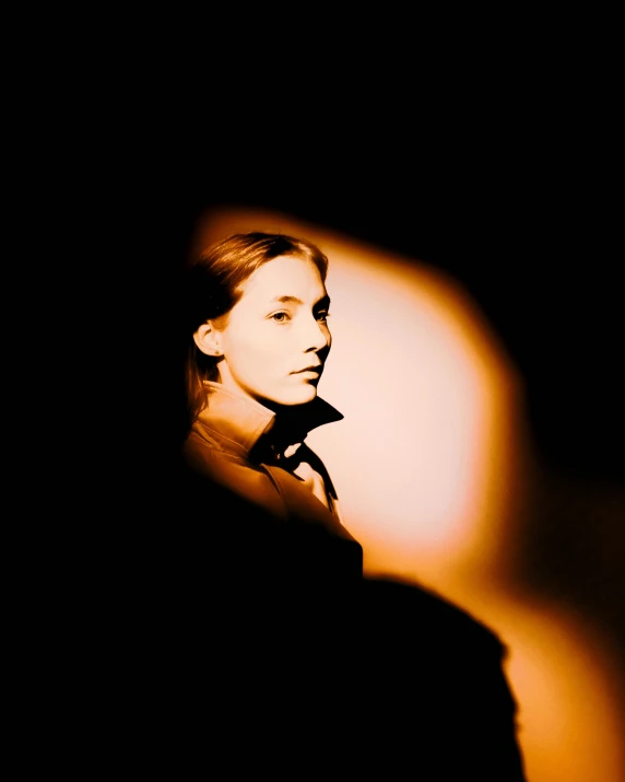 a woman that is standing in the dark, an album cover, orange light, infrared film, with high cheekbones, high contrast portra 400