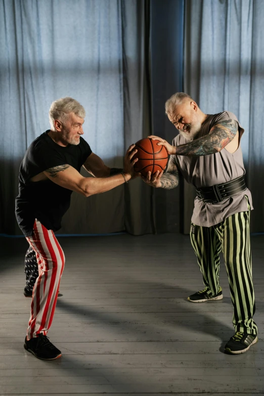 a couple of men standing next to each other holding a basketball, a tattoo, by Pavel Fedotov, bald head and white beard, choreographed fight scene, stripey pants, arthouse. y greg rutkowski