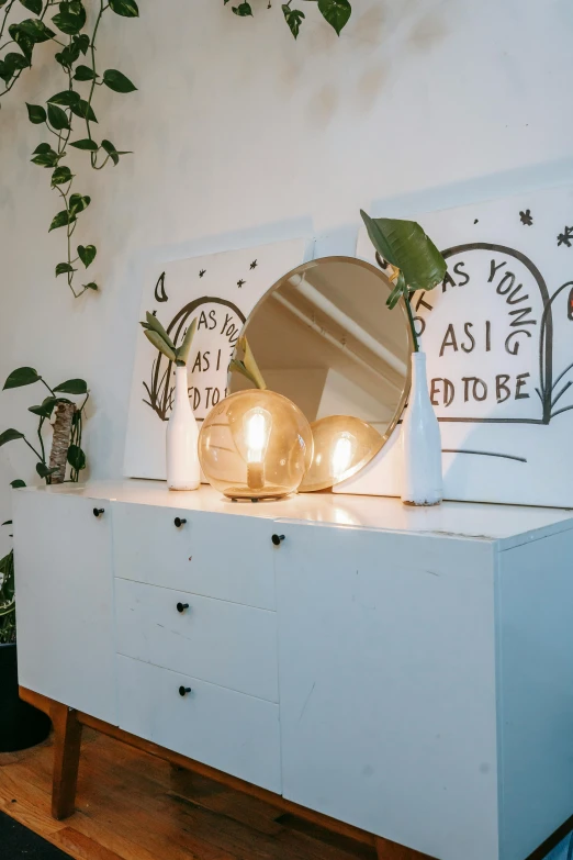 a white dresser with a mirror on top of it, a cartoon, by Jessie Alexandra Dick, light and space, terrarium lounge area, two moons lighting, taken in the early 2020s, trending photo