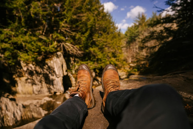 a pair of brown shoes sitting on top of a rock, new hampshire, instagram photo, lumberjack, relaxing