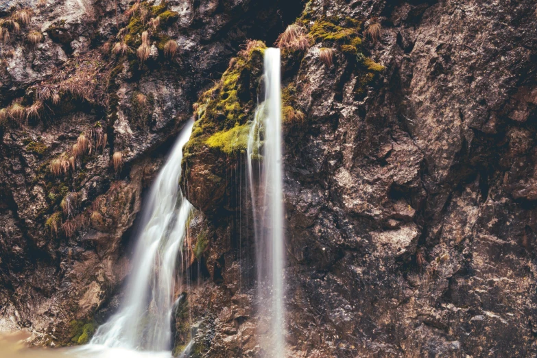 a waterfall in the middle of a rocky area, pexels contest winner, romanticism, thumbnail, brown, 90s photo, post processed