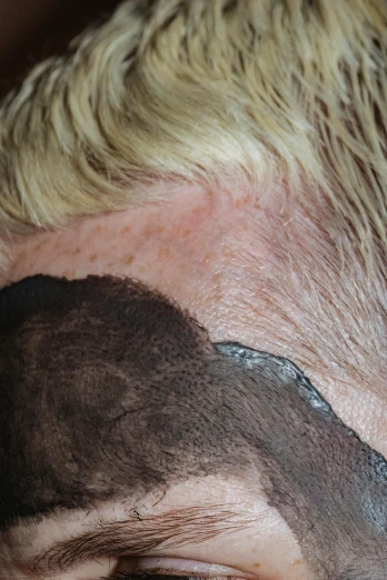 a close up of a person with a shaved head, rotting black clay skin, very very pale blond hair, half & half hair dye, visible veins