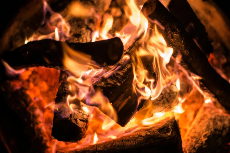 a close up of a fire in a fireplace, pexels contest winner, barrel fires and tents, avatar image, thumbnail, burning wings