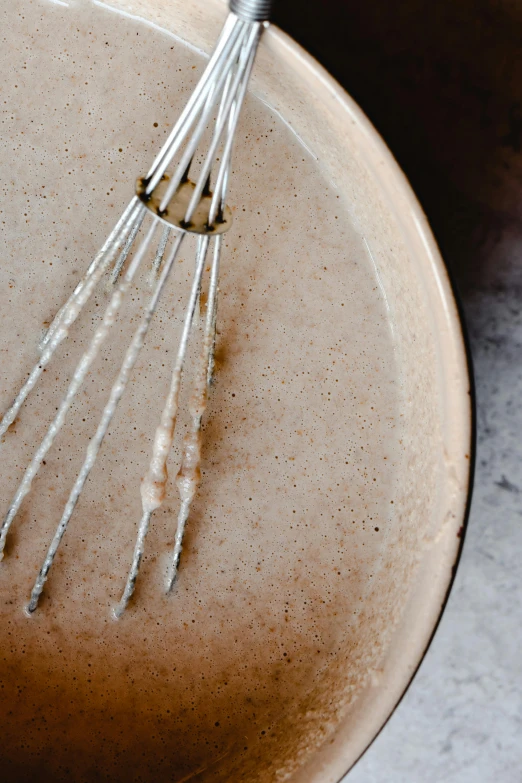 a bowl that has a whisk in it, a portrait, inspired by Ceferí Olivé, trending on unsplash, detail texture, the fork is on a plate, 4l, brown