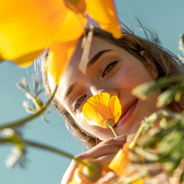 a close up of a person holding a flower, face looking skyward, pokimane, in the sun, profile image