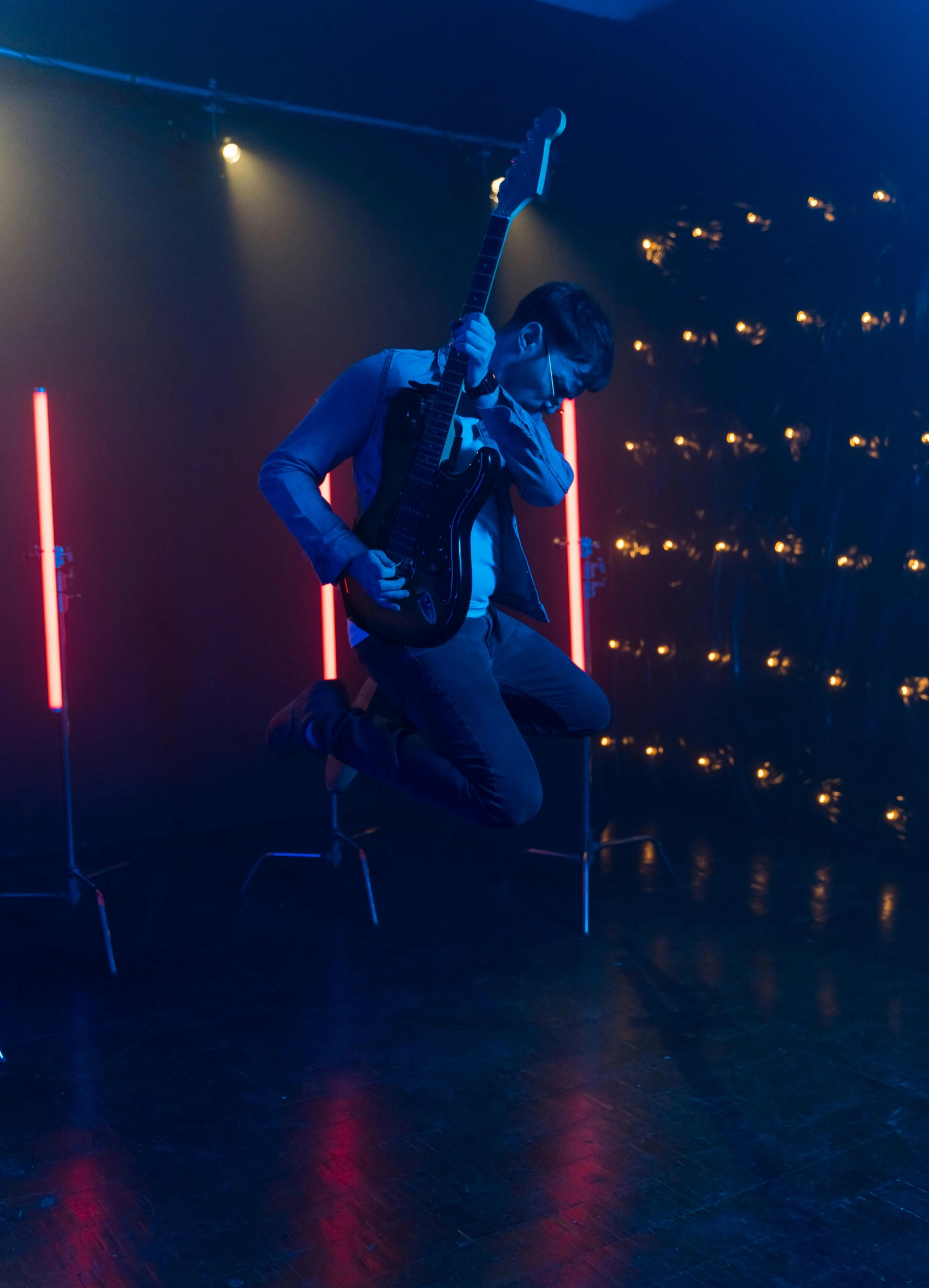 a man jumping in the air with a guitar, cinematics lighting, [ theatrical ], still from riverdale, profile image