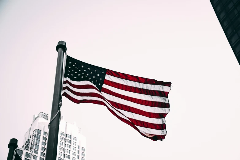 an american flag flying in front of a tall building, a photo, unsplash, profile image, instagram picture, close up image, 🚿🗝📝