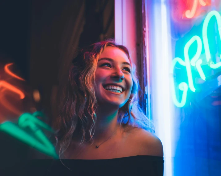 a woman smiling in front of a neon sign, pexels contest winner, sydney sweeney, neon greek, neon bar lights, profile image