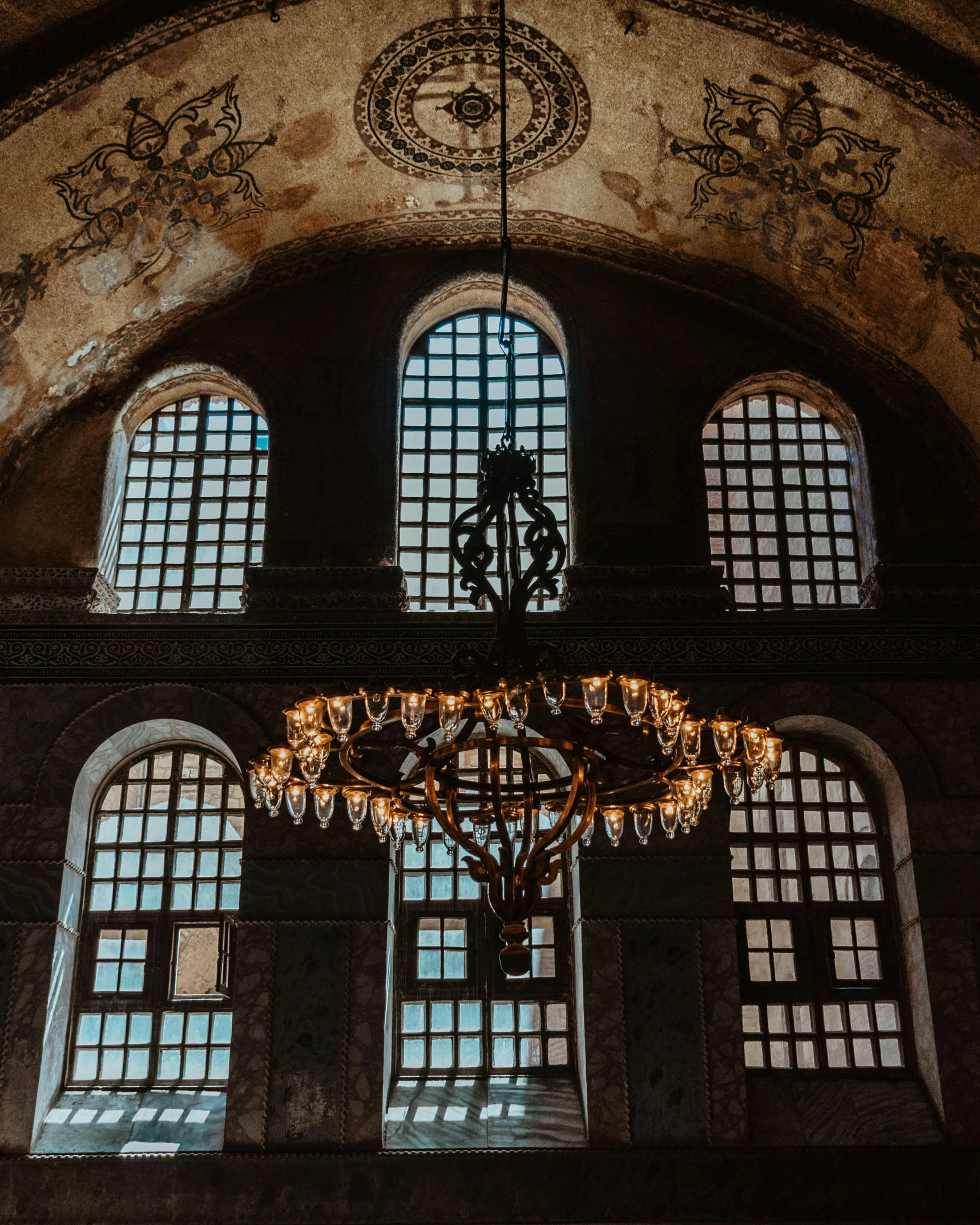 a chandelier hanging from the ceiling of a building, with great domes and arches, windows and walls :5, fan favorite, middle eastern