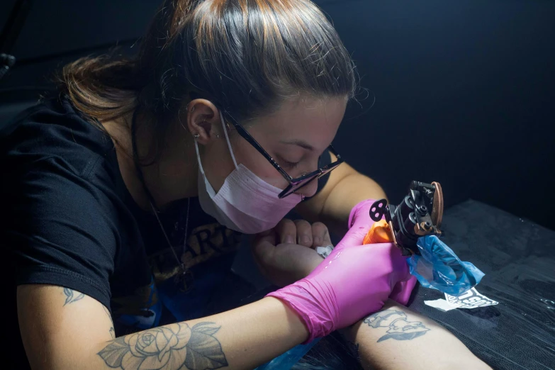 a woman getting a tattoo on her arm, tony sandoval, profile image