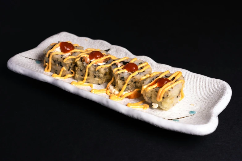 a close up of a plate of food on a table, sushi, square, cheesy, stuffed