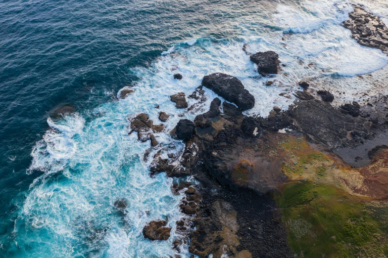 a large body of water next to a rocky shore, pexels contest winner, birdseye view, ocean swells, azores, high quality image”