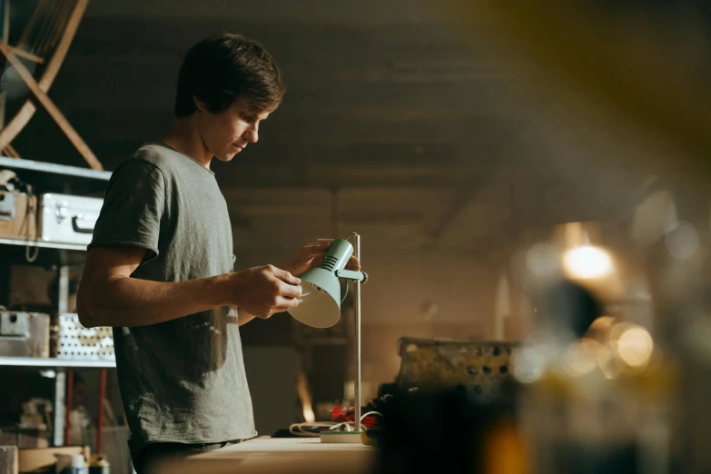 a man that is standing in a room, pexels contest winner, process art, aussie baristas, hand built ceramics, watering can, avatar image