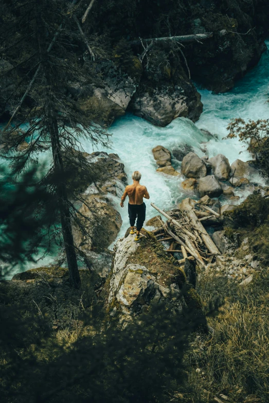 a man standing on top of a rock next to a river, lush nature, down there, banff national park, instagram post