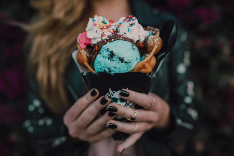 a woman holding a cone filled with ice cream and sprinkles, by Julia Pishtar, trending on pexels, blue black pink, closeup at the food, blue silver and black, 15081959 21121991 01012000 4k