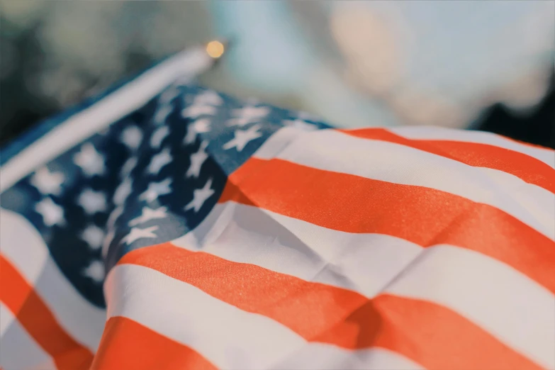 a close up of an american flag with a blurry background, pexels contest winner, 🚿🗝📝