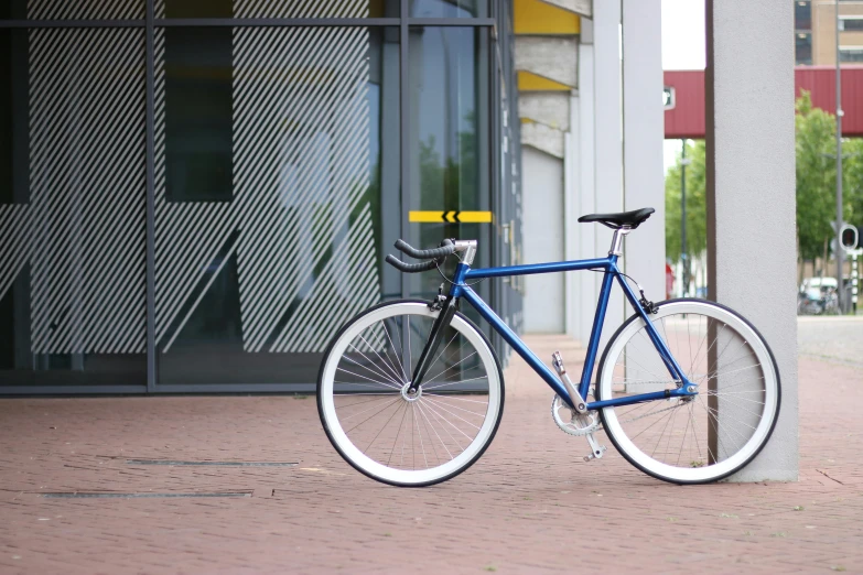 a blue bicycle parked in front of a building, profile image, kobalt blue, full product shot, urban surroundings