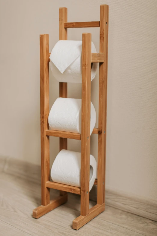 a wooden rack holding three rolls of toilet paper, designed for cozy aesthetics!, indoor picture, thumbnail, sustainable