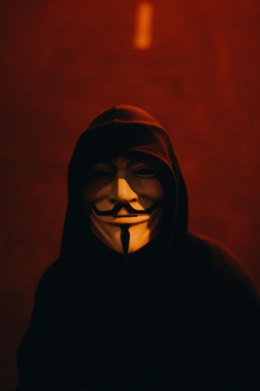 a man wearing a mask in a dark room, an album cover, pexels, red son, crazy hacker girl, pontifex, #trending