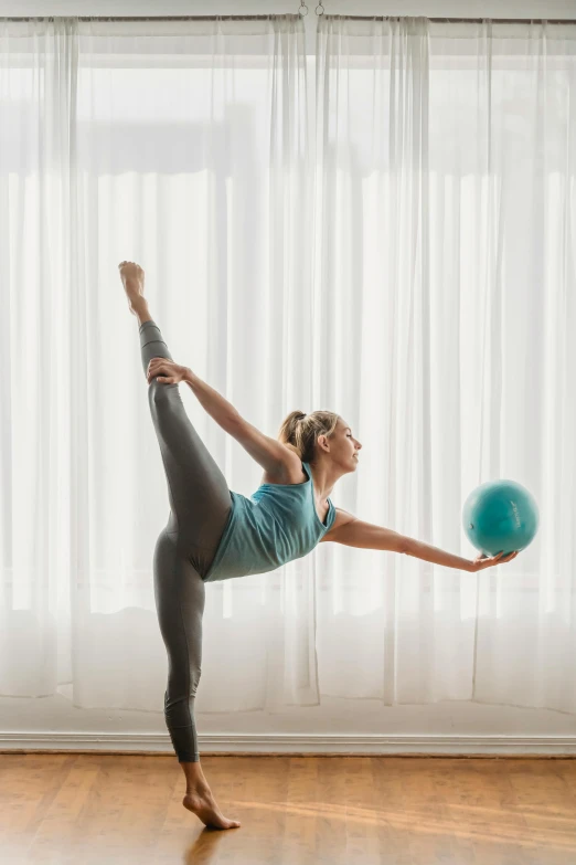 a woman doing a yoga pose with a ball, by Julian Allen, arabesque, mid - action, multi-part, standing, soft