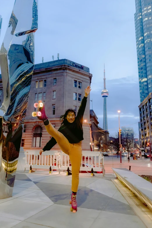 a woman standing in front of a sculpture in a city, playful pose of a dancer, cn tower, zenra taliyah, doing splits and stretching