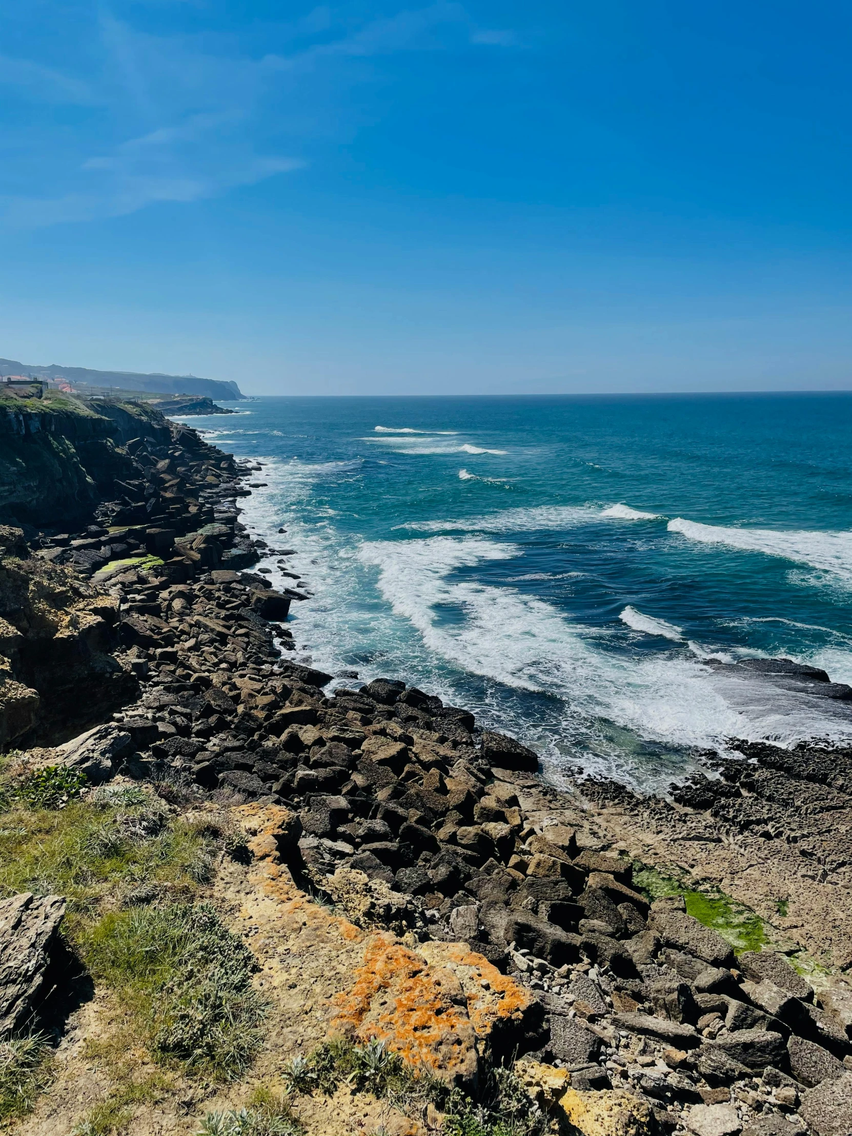 a man standing on top of a cliff next to the ocean, les nabis, whales showing from the waves, craters, rocky beach, profile image