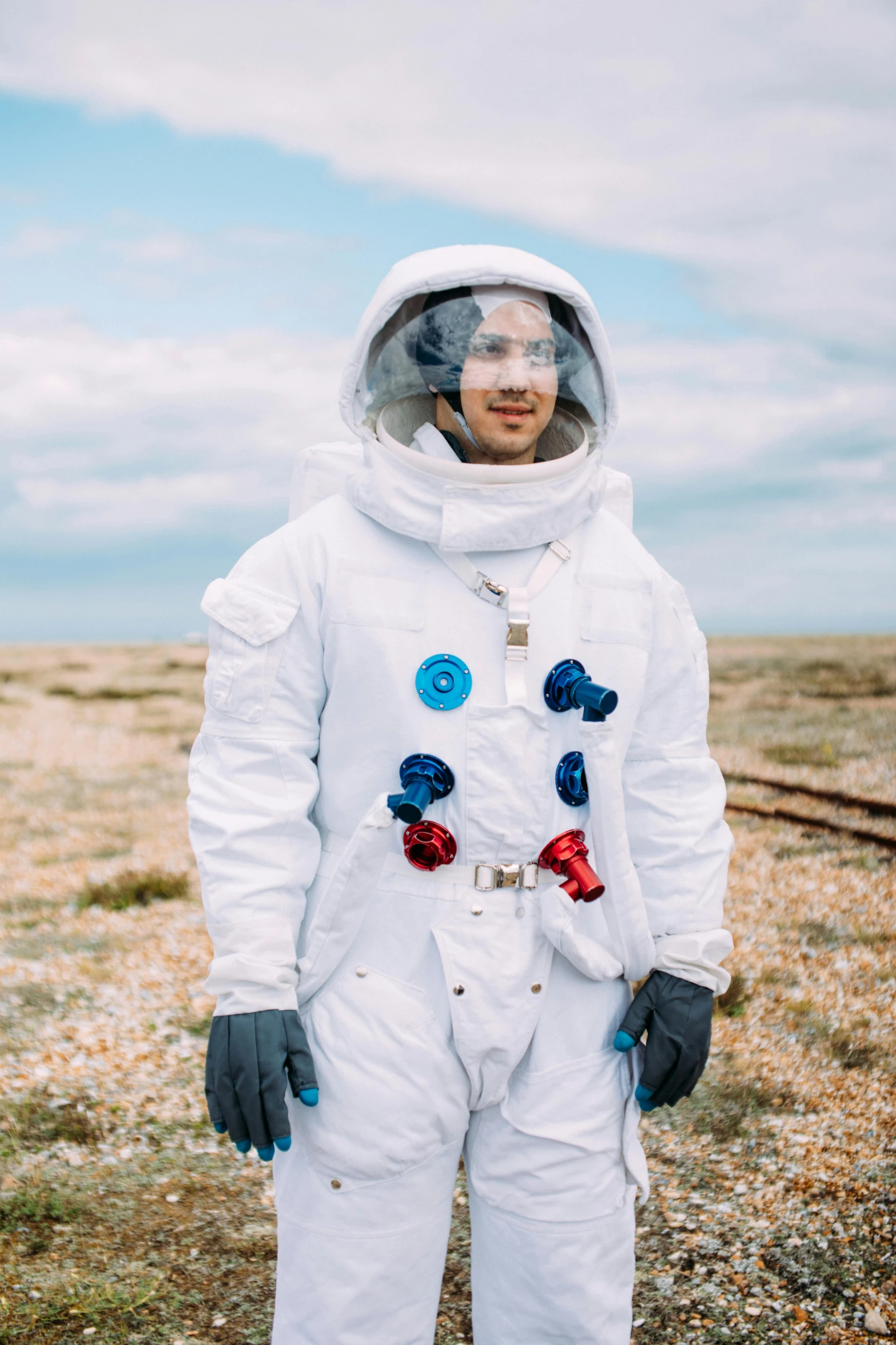 a man in a white space suit standing in a field, a colorized photo, pexels contest winner, beaches, pete davidson, mars mission, robert sheehan