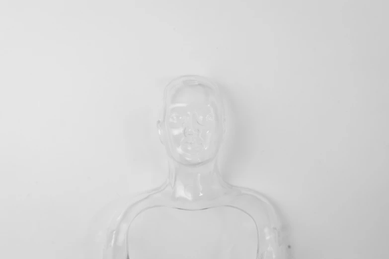 a close up of a figurine of a person, an album cover, inspired by Marina Abramović, unsplash, neo-figurative, transparent carapace, oxygen mask, on white background, made out of clear plastic